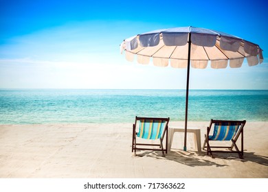 Beach Chairs And Umberella On Tropical Ocean Beach