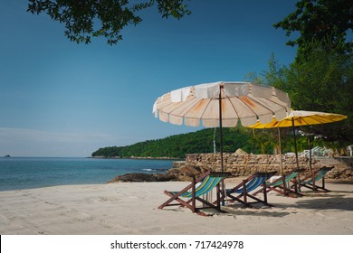 Beach Chairs And Umberella On Tropical Ocean Beach