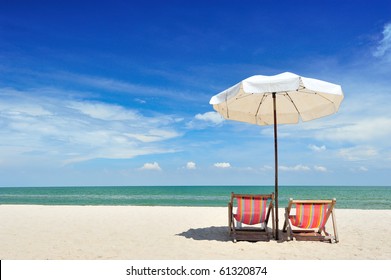 Beach Chairs With Umbrella And Beautiful Beach On A Sunny Day