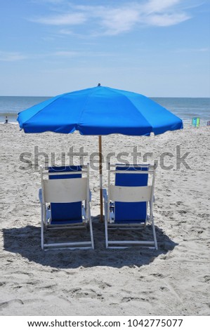 Beach chairs and umbrella on beach