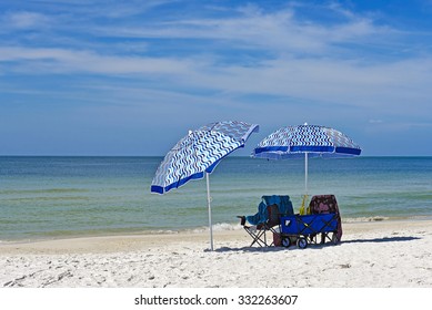 Beach Chairs With Umbrellas And A Wagon On The Beach