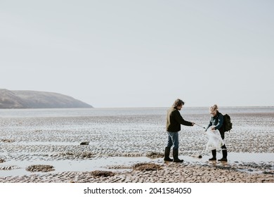 Beach cleanup volunteers picking up trash for environment campaign - Powered by Shutterstock