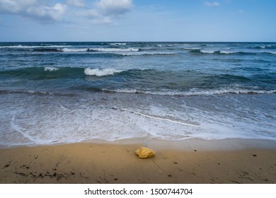 Beach of the coast of Almeria n Spain with waves and a stone in the sand of the beach. - Shutterstock ID 1500744704
