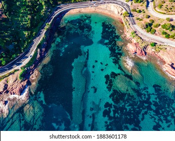 Beach And Coastline French Riviera Côte D'Azur Turquoise Colour Water With Red Rocks, Roche Rouge Alongside A Road In The Village Of Agay, Close To Cannes