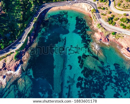 Beach and Coastline French Riviera Côte d'Azur turquoise colour water with red rocks, Roche rouge alongside a road in the village of Agay, close to Cannes
