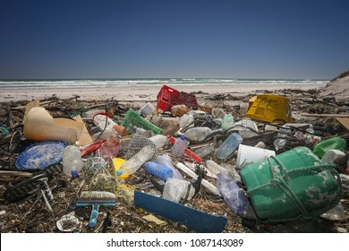 A Beach Completely Polluted By Plastic Waste Washed Up By The Ocean. 