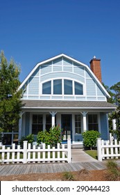 Beach Cottage With A White Fence