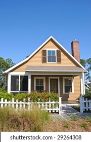 Beach Cottage With A White Fence