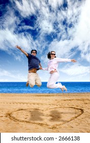 Beach Couple Having Fun Over A Heart Shape