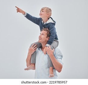 Beach, Dad And Child On Shoulders Pointing, Family Holiday Ocean Walk In Australia. Travel, Fun And Happy Father And Son Together, Smile Playing And Walking At Sea On Vacation With Cloudy Gray Sky.