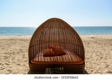 Beach Day Bed, Beach Chair With Orange Soft Cushions And Pillows, Wicker Patio And Outdoor Furniture, Rattan Garden Furniture, Exterior Furniture.