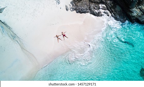 Beach Drone View Tropical Island, White Beach With Waves, Couple Lay Down On The Beach Man And Woman