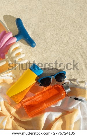 Beach Essentials with Hat, Sunscreen, Water Bottle and Toys. Summer Vacation Flatlay