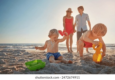 Beach, family and children building sand castle in summer for holiday, travel or vacation together. Mother, father and kids outdoor on tropical island coast for adventure, bonding or development - Powered by Shutterstock