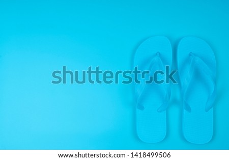 Beach flip-flop on the blue background with copy space. Summer is concept
