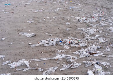 Beach full of garbage, wet wipes and waste that people throw in the toilet. Concept of ocean pollution and environmental destruction