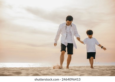 Beach fun with a cheerful Asian father and son running hand in hand. Laughing playing and enjoying the sun this family moment is full of joy and togetherness. - Powered by Shutterstock