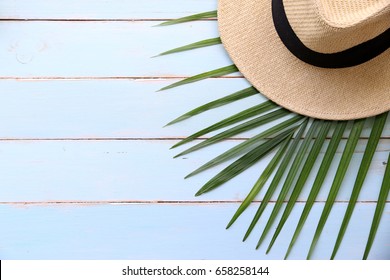 Beach Hat And Coconut Leaves On Wooden Table In The Summer Asia,copy Space,Top View,minimal Style