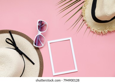 Beach hat,coconut leaves and glasses on pink background In the summer Asia,copy space,Top view,minimal style