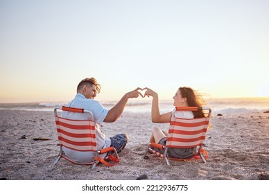 Beach, Heart Sign And Couple With Love In Summer And Ocean On Sunset Sky And Happy. Mockup Space Of Man, Woman Or Gen Z People With Hands, Icon Or Emoji For Outdoor Summer Vacation Or Romantic Date