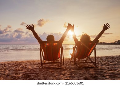 beach holidays, happy retired couple enjoying sunset near the sea, holding hands