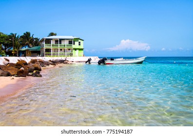 A Beach House And Boat In The Caribbean Sea. Corn Islands, Nicaragua.