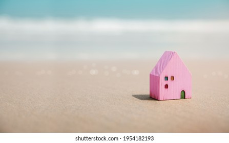 Beach House Concept. Mini Colorful Wooden Villa On The Front Sand Beach. Destination For Vacation Or Retirement Life. Summer Sunny Day. Metaphor Photo