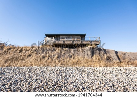 Beach House Teetering on the Edge of an Eroding Cliff on Martha's Vineyard