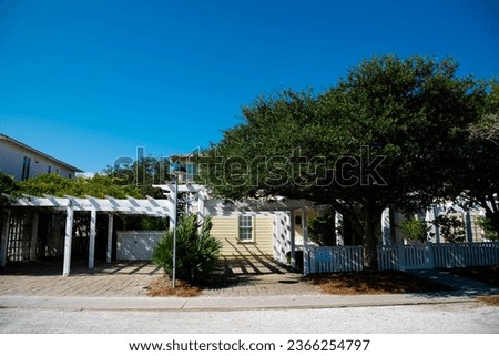 Beach houses with white picket fence and pergola along scenic 30A country road in Santa Rosa, South Walton Beaches near Destin and Florida Panhandle. Residential and vacation homes clear blue sky Stock photo © 