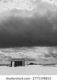 Beach hut under dramatic storm sky - Sandbanks Provincial Park, Newfoundland, Canada