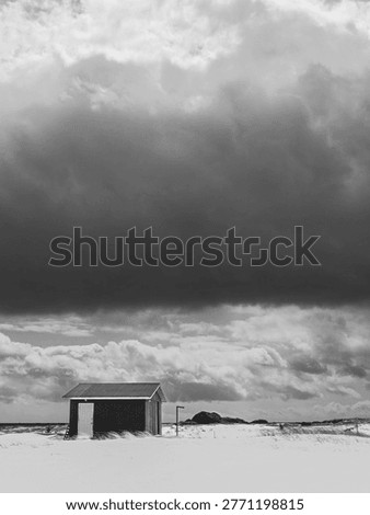 Beach hut under dramatic storm sky - Sandbanks Provincial Park, Newfoundland, Canada