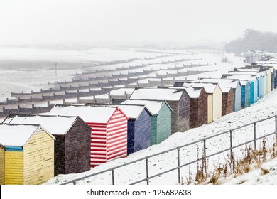 Beach huts along the seaside during a snow storm - Powered by Shutterstock