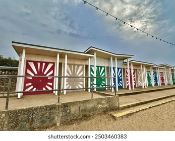 Beach huts with cloudy sky - Powered by Shutterstock