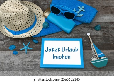 Beach items with the text book your vacation now. The German inscription translates as book your vacation now.