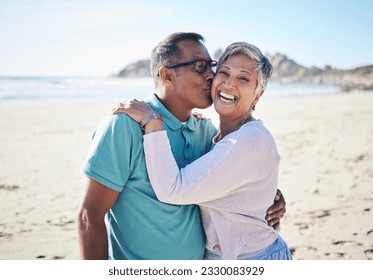 Beach, kiss and portrait of senior couple for bonding, quality time and relax in nature. Love, retirement and happy elderly man and woman embrace by ocean on holiday, vacation and travel in morning - Powered by Shutterstock