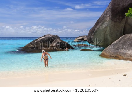 beach in the lagoon with white sand rocky shore and tourists