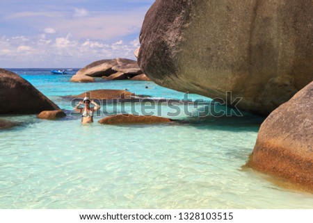 beach in the lagoon with white sand rocky shore and tourists
