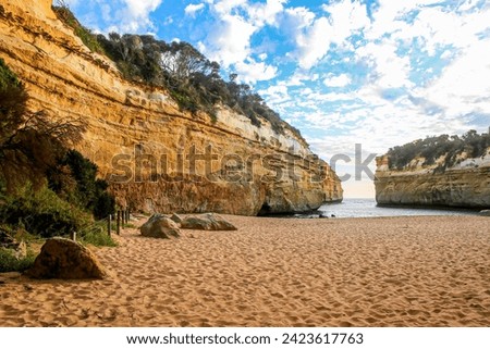 Beach in Loch Ard Gorge surrounded by sandstone cliffs at the Twelve Apostles Marine National Park along the Great Ocean Road in Victoria, Australia