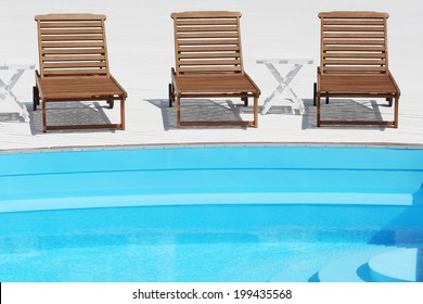 Beach Lounge Chair Near The Pool On White Boards