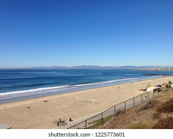 The Beach Near Los Angeles Looking North During The Day With A Beach Volleyball Net In View.