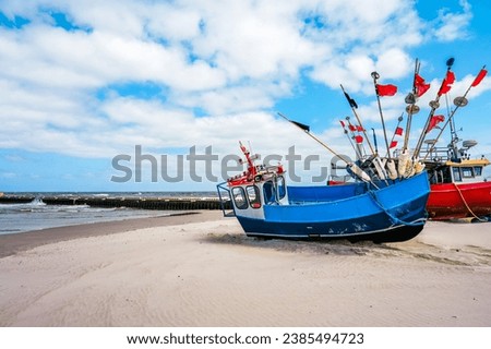 Beach near Niechorze in Poland. Natural coast on the Polish Baltic Sea with white sand and fishing boats. Landscape by the sea.