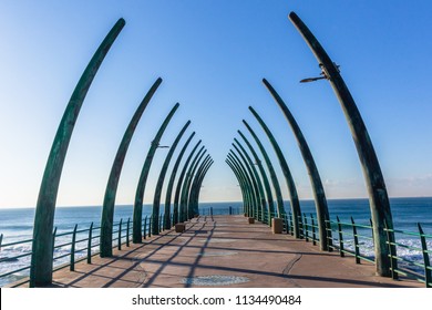 Beach ocean pier jetty with structure designed elephant tusks morning blue sky horizon landscape. - Shutterstock ID 1134490484