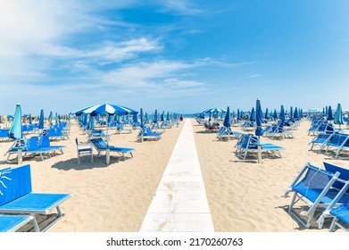Beach on Italian riviera with walkway to seashore
