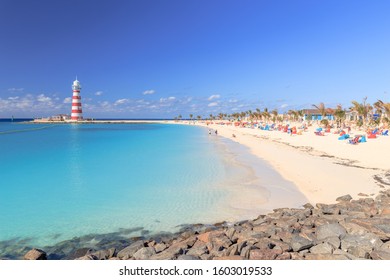Beach on Ocean Cay Bahamas Island with a lighthouse and turquoise water