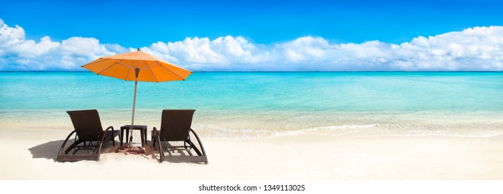 Beach panorama with beach chair and sun shade as background image