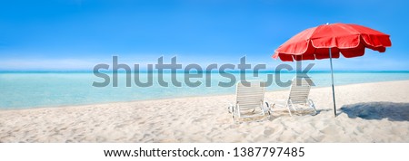 Beach panorama with sun chairs and parasol as background image