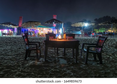 Beach Party At Night In Beach Cafe With Bottle Of Rose Wine And Glasses On The Table , GOA, India..