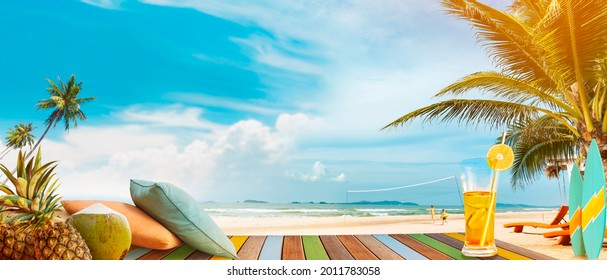 Beach Party And Relaxation. On The Table Are A Pillow, Drinks, And Tropical Fruits. Family Fun Summer Vacation.