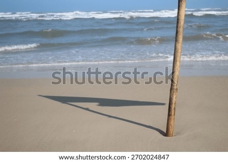 Beach pole casting a shadow