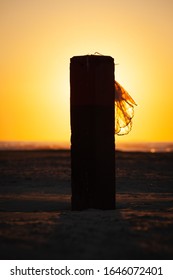 Beach pole in the setting sun